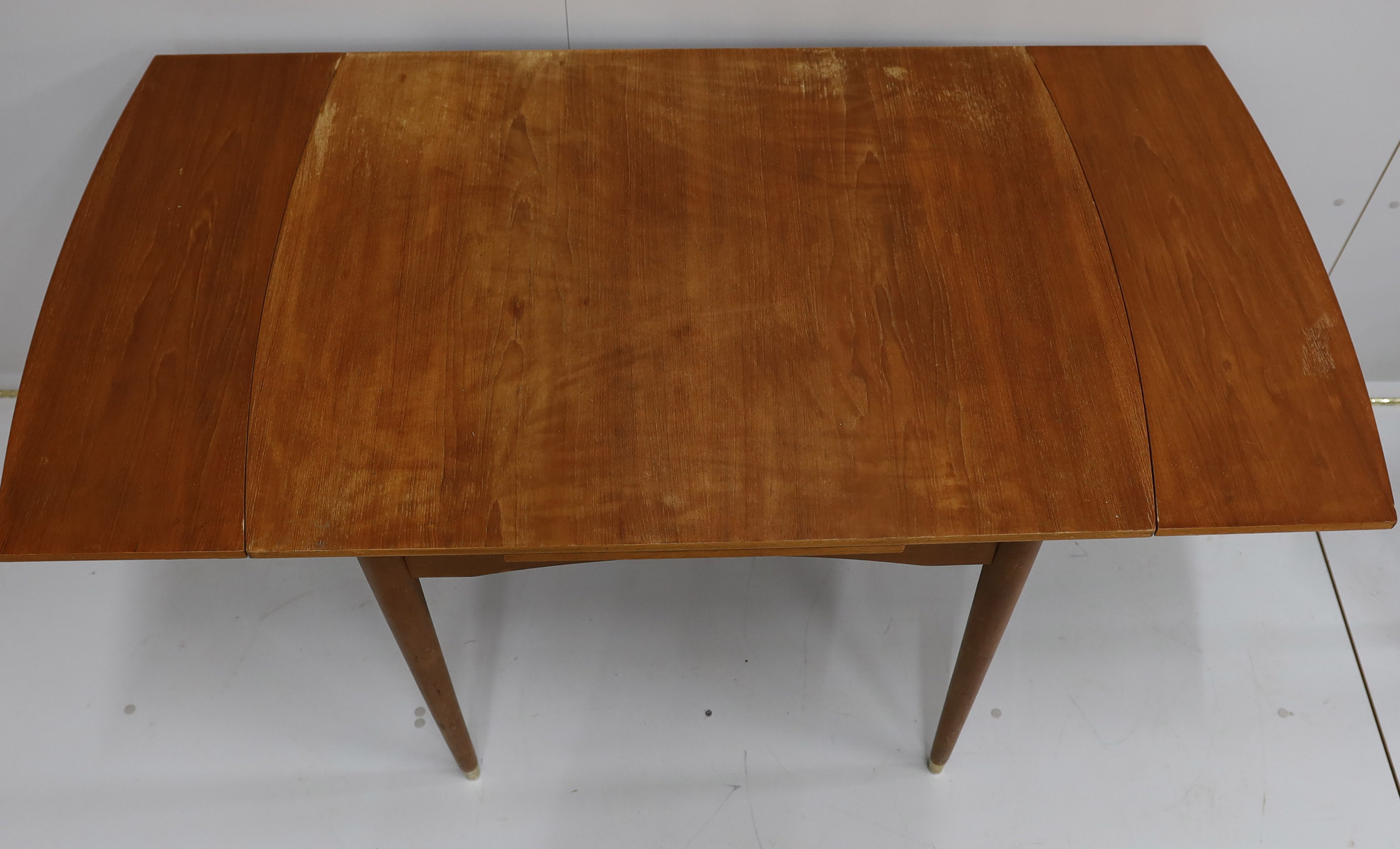 A mid century McInstosh teak draw leaf dining table, 150cm extended, depth 76cm, height 77cm and four chairs